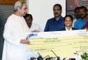 Odisha CM Naveen Patnaik hands over Rs.3 crore cheque to Dutee Chand